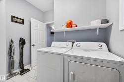 Laundry area featuring washer and dryer and light marble finish flooring - 