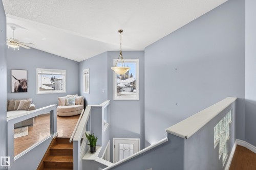 Stairs with wood finished floors and a ceiling fan - 24 Olmstead Court, St. Albert, AB - Indoor Photo Showing Other Room