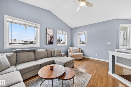 Living room with hardwood / wood-style flooring, lofted ceiling, and a ceiling fan - 24 Olmstead Court, St. Albert, AB - Indoor Photo Showing Living Room