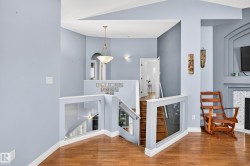 Stairway with wood finished floors and a towering ceiling - 