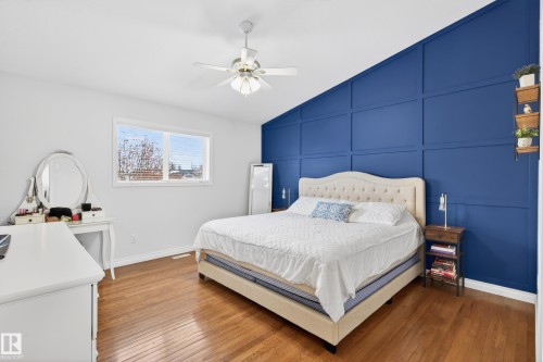 Bedroom with a decorative wall, hardwood / wood-style floors, lofted ceiling, and ceiling fan - 24 Olmstead Court, St. Albert, AB - Indoor Photo Showing Bedroom
