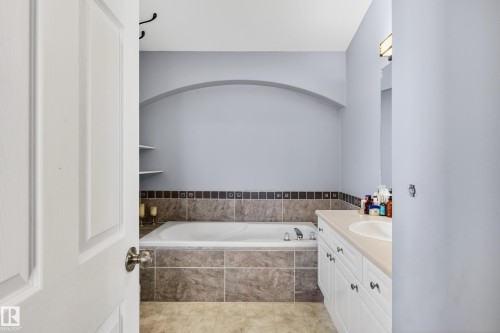 Bathroom featuring vanity, a bath, and light tile patterned floors - 24 Olmstead Court, St. Albert, AB - Indoor Photo Showing Bathroom
