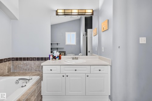 Bathroom featuring vanity, a bath, and lofted ceiling - 24 Olmstead Court, St. Albert, AB - Indoor Photo Showing Bathroom