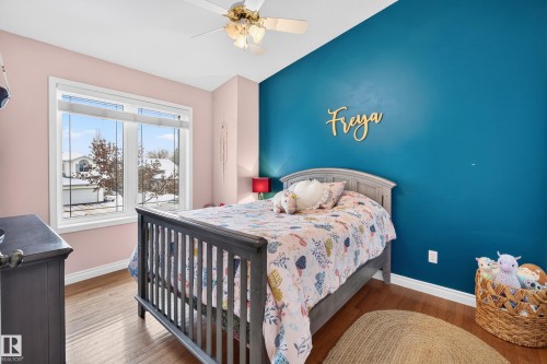 Bedroom featuring hardwood / wood-style flooring and ceiling fan - 24 Olmstead Court, St. Albert, AB - Indoor Photo Showing Bedroom