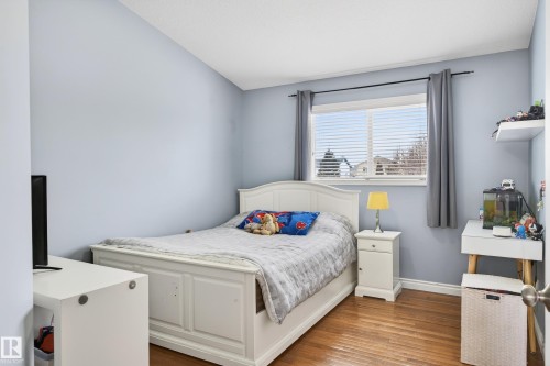 Bedroom featuring light wood finished floors and vaulted ceiling - 24 Olmstead Court, St. Albert, AB - Indoor Photo Showing Bedroom