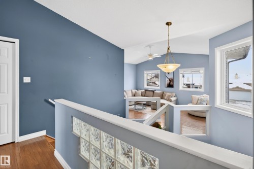 Hall with an upstairs landing, lofted ceiling, and dark wood-type flooring - 24 Olmstead Court, St. Albert, AB - Indoor Photo Showing Other Room