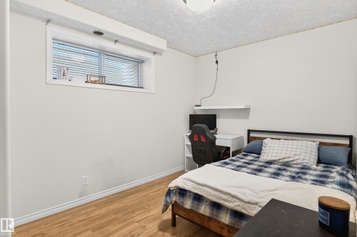 Bedroom with wood finished floors and a textured ceiling - 24 Olmstead Court, St. Albert, AB - Indoor Photo Showing Bedroom