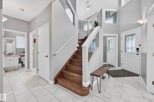 Entrance foyer featuring light marble finish flooring, stairway, and a high ceiling - 24 Olmstead Court, St. Albert, AB - Indoor Photo Showing Other Room