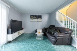Carpeted living room with ornamental molding, a textured ceiling, and stairs - 