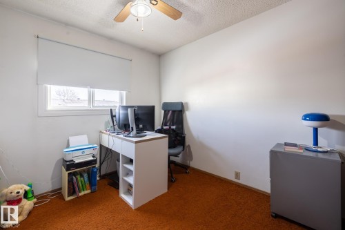 Carpeted office with a textured ceiling and ceiling fan - 1346 Lakewood Road W, Edmonton, AB - Indoor Photo Showing Office