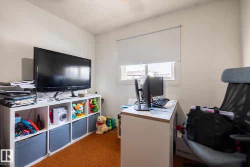 Office with dark carpet and a textured ceiling - 1346 Lakewood Road W, Edmonton, AB - Indoor