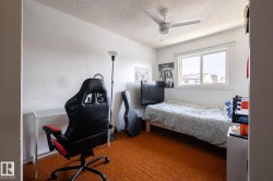 Bedroom featuring carpet floors, a textured ceiling, and a ceiling fan - 