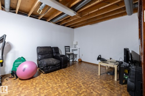 Workout room featuring parquet flooring and baseboards - 1346 Lakewood Road W, Edmonton, AB - Indoor Photo Showing Basement