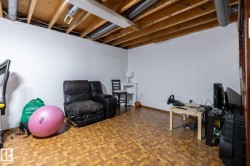 Workout room featuring parquet flooring and baseboards - 