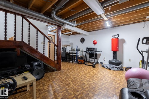 Exercise room featuring parquet flooring - 1346 Lakewood Road W, Edmonton, AB - Indoor Photo Showing Basement
