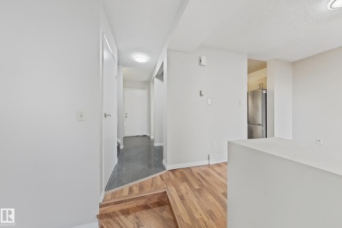 Corridor featuring light wood-type flooring and baseboards - 24 3812 20 Avenue, Edmonton, AB - Indoor Photo Showing Other Room