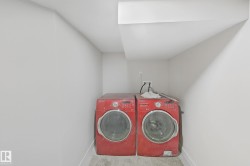 Laundry room with washing machine and dryer and baseboards - 