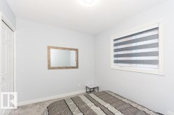 Unfurnished bedroom featuring carpet flooring, a textured ceiling, and a closet - 