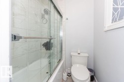 Full bath with combined bath / shower with glass door and toilet - 