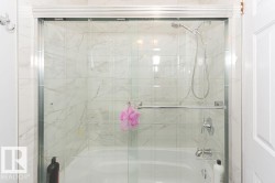 Full bathroom featuring combined bath / shower with glass door - 