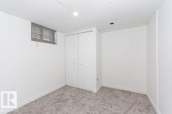 Unfurnished bedroom with carpet flooring, a closet, a paneled ceiling, and recessed lighting - 