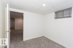 Finished below grade area with carpet floors and a drop ceiling - 