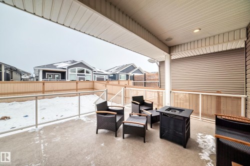 Fenced backyard with a patio, an outdoor living space with a fire pit, and a residential view - 6 Wade Avenue, Leduc, AB - Outdoor With Deck Patio Veranda With Exterior