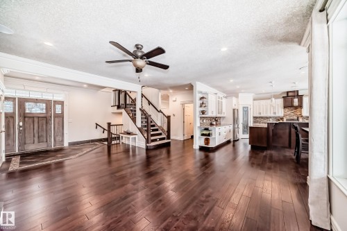 Living area with stairway, a textured ceiling, dark wood-type flooring, recessed lighting, and a ceiling fan - 6 Wade Avenue, Leduc, AB - Indoor Photo Showing Living Room