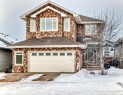 View of front of house with stone siding, a shingled roof, and an attached garage - 6 Wade Avenue, Leduc, AB  - Outdoor 