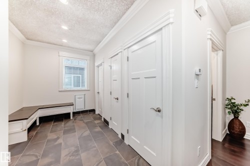 Mudroom with a textured ceiling and crown molding - 6 Wade Avenue, Leduc, AB - Indoor Photo Showing Other Room