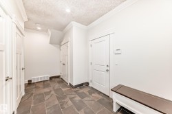 Mudroom with a textured ceiling and crown molding - 