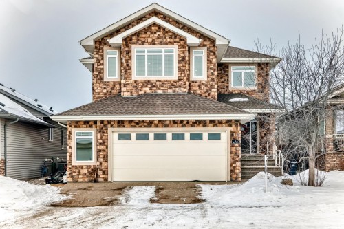 View of front of home featuring stone siding and a shingled roof - 6 Wade Avenue, Leduc, AB - Outdoor With Facade