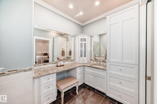 Ensuite bathroom with vanity, dark tile patterned floors, recessed lighting, and crown molding - 6 Wade Avenue, Leduc, AB - Indoor Photo Showing Bathroom