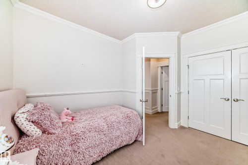 Carpeted bedroom with crown molding and a closet - 6 Wade Avenue, Leduc, AB - Indoor Photo Showing Bedroom