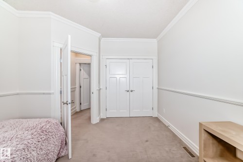 Bedroom with carpet flooring, ornamental molding, and a closet - 6 Wade Avenue, Leduc, AB - Indoor