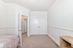 Bedroom with carpet flooring, ornamental molding, and a closet - 