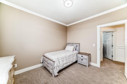 Bedroom with crown molding and light carpet - 