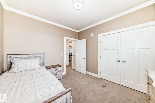 Bedroom featuring carpet flooring, ornamental molding, and a closet - 6 Wade Avenue, Leduc, AB - Indoor Photo Showing Bedroom