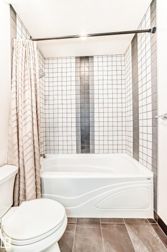 Full bath with shower / tub combo and tile patterned flooring - 6 Wade Avenue, Leduc, AB - Indoor Photo Showing Bathroom