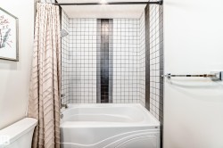 Full bath featuring shower / bath combination with curtain and toilet - 