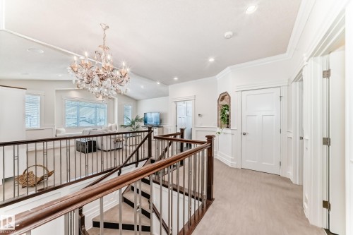 Hallway with an upstairs landing, light colored carpet, a chandelier, recessed lighting, and lofted ceiling - 6 Wade Avenue, Leduc, AB - Indoor Photo Showing Other Room