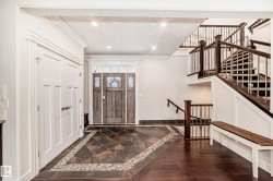Foyer with inlaid floor details, recessed lighting, dark wood-style flooring, and crown molding - 