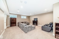 Living area featuring a fireplace, recessed lighting, and light colored carpet - 
