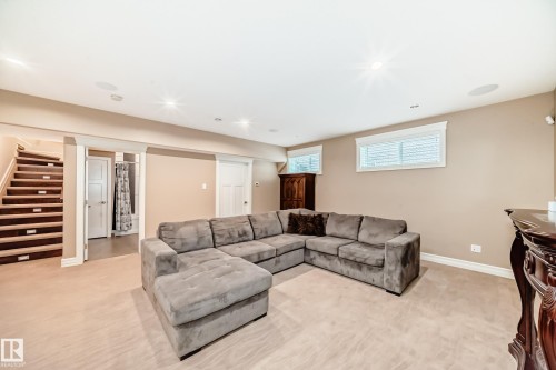 Living room with light carpet, stairs, and recessed lighting - 6 Wade Avenue, Leduc, AB - Indoor