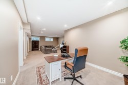 Office space with light colored carpet and recessed lighting - 