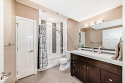 Bathroom with vanity and shower / tub combo with curtain - 