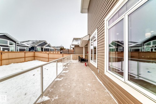Yard covered in snow with a fenced backyard and a residential view - 6 Wade Avenue, Leduc, AB - Outdoor With Exterior