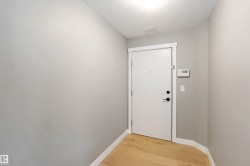 Entryway featuring wood finished floors and a textured ceiling - 