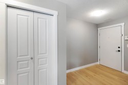 Foyer entrance with light wood finished floors and a textured ceiling - 