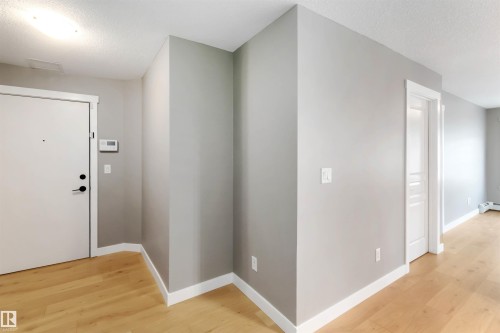 Hall featuring a textured ceiling and light wood-style flooring - 101 3670 139 Avenue, Edmonton, AB - Indoor Photo Showing Other Room